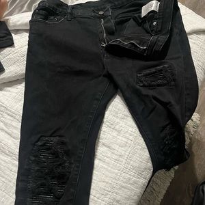 Black skinny jeans with design patches, size 36 waist worn once.
